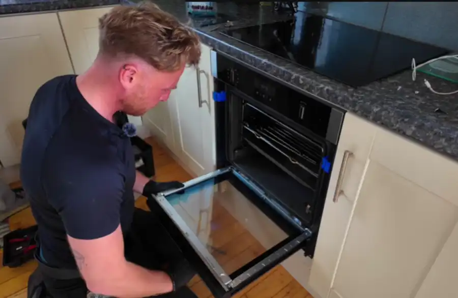 Technician repairing a kitchen oven in Abilene, TX
